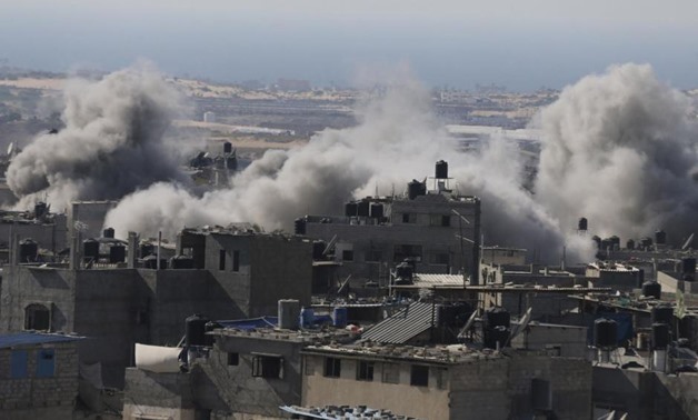 Smoke is seen following what police said was an Israeli air strike in Rafah in the southern Gaza Strip July 9, 2014. REUTERS/Ibraheem Abu Mustafa. “

