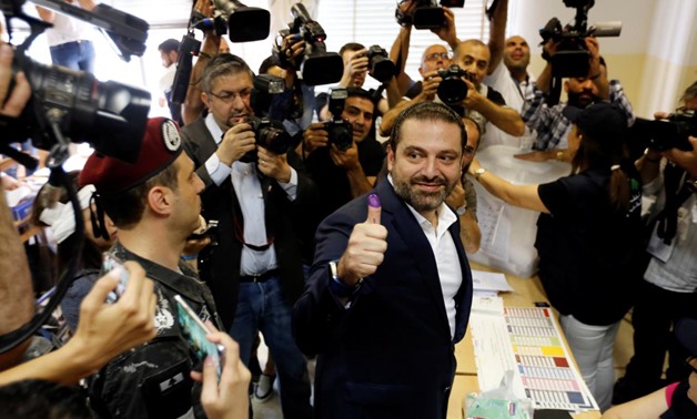 Lebanese prime minister and candidate for the parliamentary election Saad al-Hariri shows his ink-stained finger after casting his vote during the parliamentary election in Beirut, Lebanon, May 6, 2018. REUTERS/Jamal Saidi
