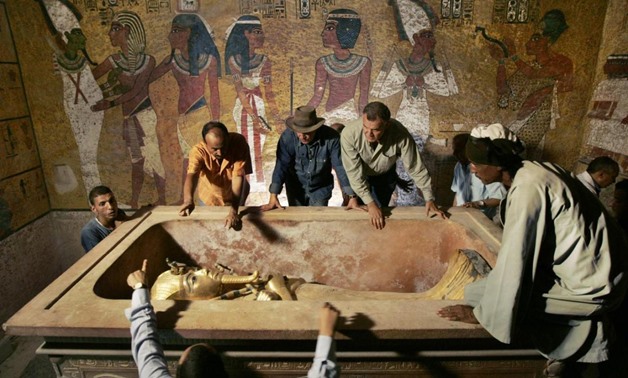 Zahi Hawass (back, 3rd L), head of the High Council for Antiquities, supervises the removal of the mummy of King Tutankhamen from his stone sarcophagus in his underground tomb in the Valley of the Kings in Luxor in this November 4, 2007 file photo. REUTER