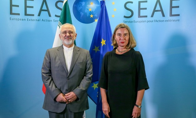 Foreign Minister of Iran Mohammad Javad Zarif (L) is welcomed by European Union Foreign Policy Chief Federica Mogherini in Brussels last month

