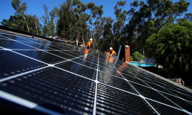 Solar installers from Baker Electric place solar panels on the roof of a residential home in Scripps Ranch, San Diego, California, U.S. October 14, 2016.
