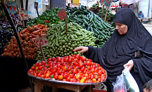 An Egyptian woman buying vegetables from a local market in Cairo - FILE 