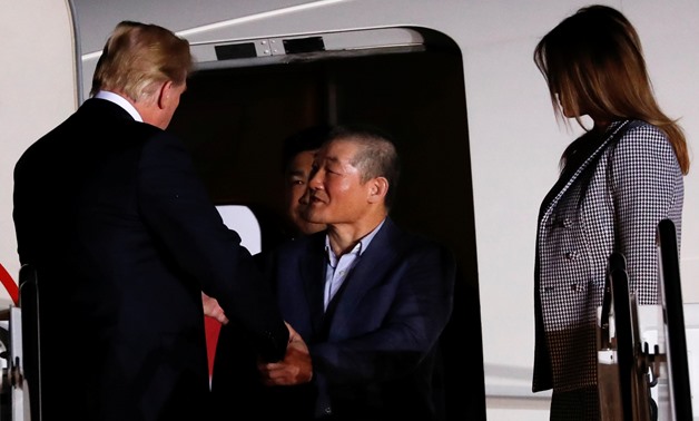 U.S. President Donald Trump and first lady Melania Trump greet the Americans formerly held hostage in North Korea, upon their arrival at Joint Base Andrews, Maryland, U.S., May 10, 2018. REUTERS/Jonathan Ernst