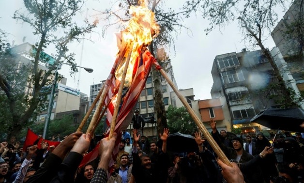 Iranians burn US flags during an anti-US demonstration outside the former US embassy headquarters in the capital Tehran on May 9, 2018
