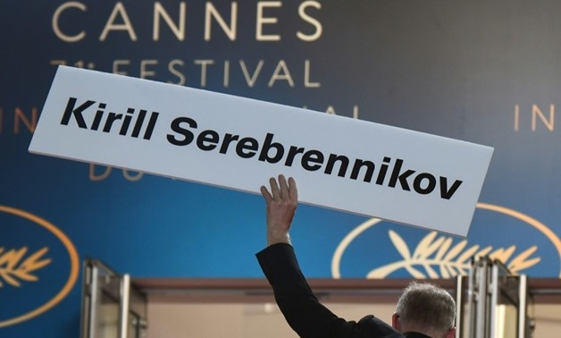 The General Delegate of the Cannes Film Festival Thierry Fremaux holds a cardboard bearing the name of Russian director Kirill Serebrennikov ahead of the screening of his film "Leto (Summer)". He is under house arrest in Moscow and barred from attending t