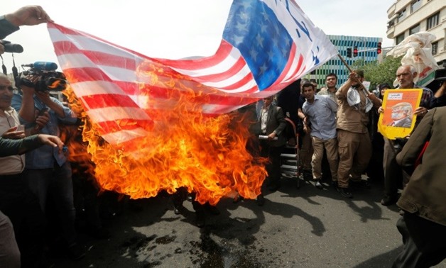 Iranians set fire to a US flag during a demonstration in Tehran on May 11, 2018
