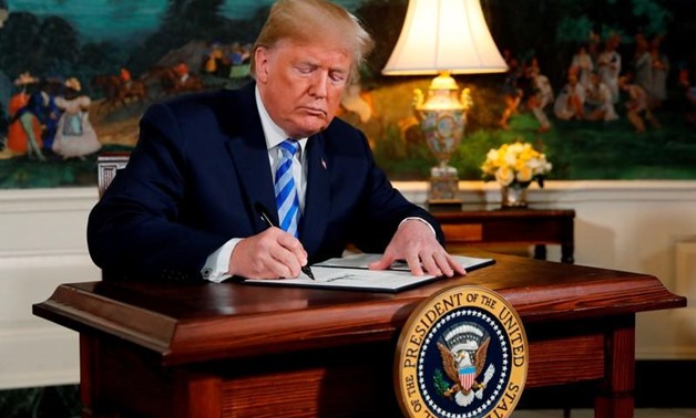 In a May 8 event at the White House, U.S. President Donald Trump signs a proclamation declaring his intention to withdraw from the Iran nuclear agreement. REUTERS/Jonathan Ernst
