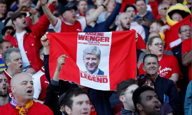 Premier League - Huddersfield Town vs Arsenal - John Smith's Stadium, Huddersfield, Britain - May 13, 2018 Arsenal fans hold up a banner in reference to manager Arsene Wenger at the end of the match Action Images via Reuters