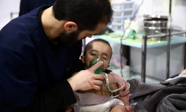 Man with a child are seen in hospital in the besieged town of Douma, Eastern Ghouta, Damascus, Syria February 25, 2018. Picture taken February 25, 2018 -  REUTERS
