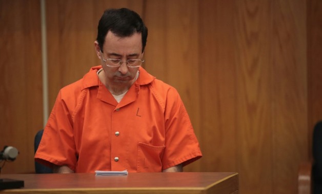Larry Nassar was sentenced in January 2018 to spend his life behind bars after pleading guilty to sexually assaulting women and girls over a two-decade period under the guise of medical treatment - AFP

