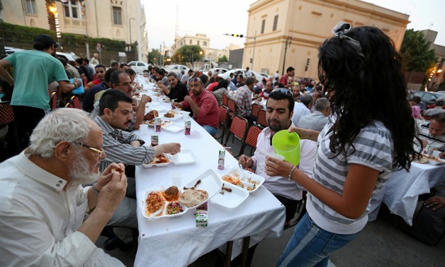 A Christian girl helps in one of the Ramadan Banquets prepared for fasting Muslims in Cairo. REUTERS/Mohamed Abd El Ghany
