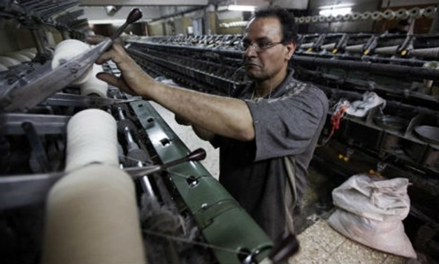 A file photo of a Mahalla textile and weaving company worker (Photo:Reuters)

