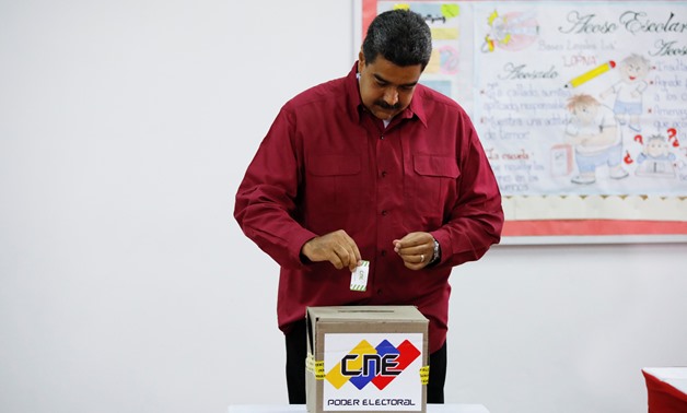 Venezuela's President Nicolas Maduro casts his vote at a polling station, during the presidential election in Caracas, Venezuela May 20, 2018. REUTERS/Carlos Garcia Rawlins
