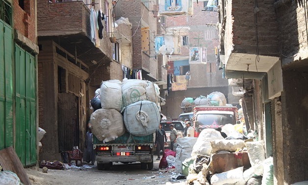 A garbage truck driving through the Streets of Manshiyat Nasser, Mokattam, Cairo - Courtesy to Wikimedia Commons