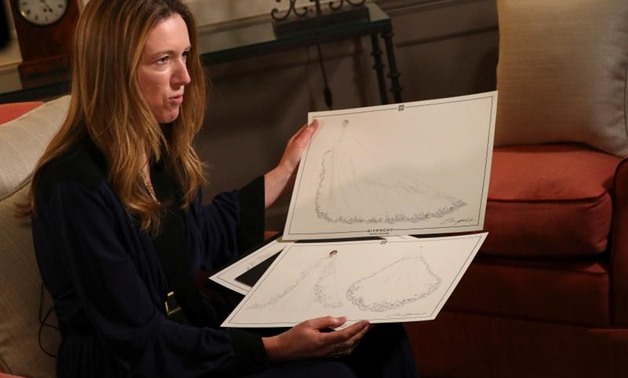 Clare Waight Keller, designer at Givenchy, holds sketches as she gives an interview the day after Meghan Markle walked down the aisle of St George's Chapel in Windsor and married Prince Harry wearing the dress that she created, in Kensington Palace, Londo