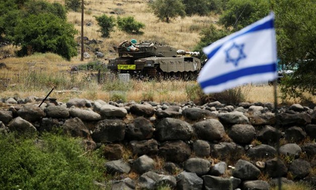 An Israeli tank can be seen near the Israeli side of the border with Syria in the Israeli-occupied Golan Heights, Israel May 9, 2018. REUTERS/Amir Cohen