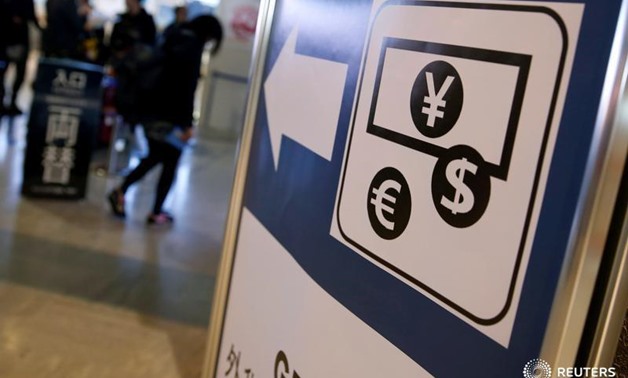 Currency signs of Japanese Yen, Euro and the U.S. dollar are seen on a board outside a currency exchange office at Narita International airport, near Tokyo, Japan, March 25, 2016. REUTERS/Yuya Shino/File Photo