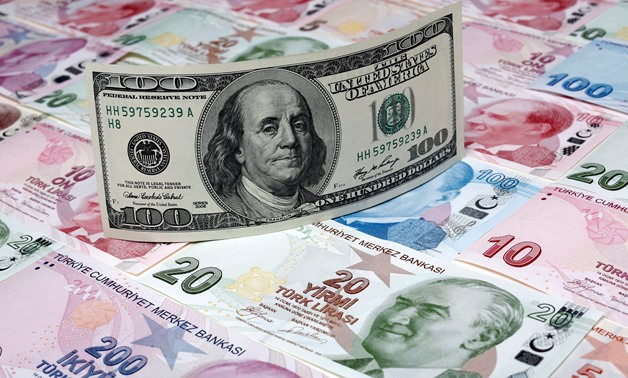 A photo illustration taken in Istanbul shows a U.S. 100 dollar banknote against Turkish lira banknotes of various denominations January 7, 2014. REUTERS/Murad Sezer/Illustration/File Photo