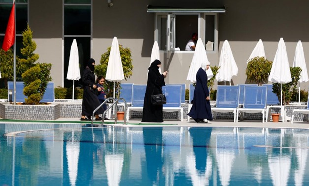 Guests walk by the pool at Elvin Deluxe Hotel, a halal friendly holiday resort, in Alanya, Turkey April 18, 2018. REUTERS/Osman Orsal