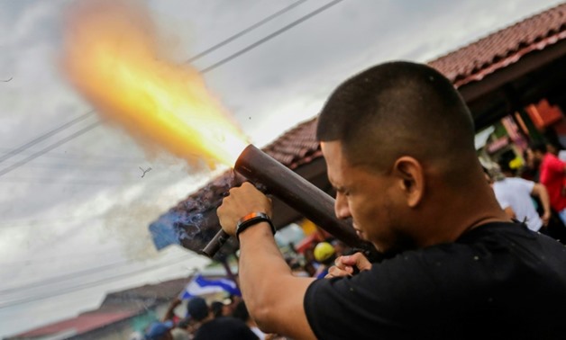 A Nicaraguan university student opposed to President Daniel Ortega fires a hand-held mortar in a neighbourhood in Masaya, a city that was a cradle of the Sandinista movement but is now a hotbed of anti-government resistance
