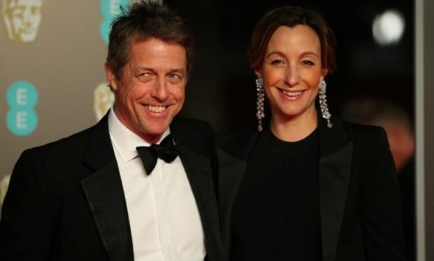 Hugh Grant and Anna Eberstein arrive for the British Academy of Film and Television Awards (BAFTA) at the Royal Albert Hall in London, Britain, February 18, 2018. REUTERS/Hannah McKay