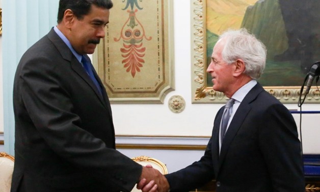 Venezuelan President Nicolas Maduro (L) greets US senator Bob Corker (R) during the latter's visit to the Miraflores presidential palace in Caracas on May 25, 2018
