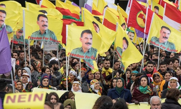 Kurdish protesters demonstrate with placards reading "No to dictatorship" and the portrait of the leader of the Kurdistan PKK Workers' Party, Abdullah Ocalan in the city center of Frankfurt am Main, western Germany, on March 18, 2017. (AFP Photo/dpa/Boris
