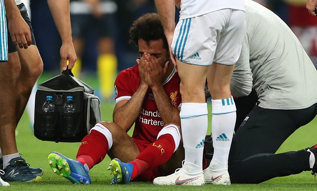 Champions League Final - Real Madrid v Liverpool - NSC Olympic Stadium, Kiev, Ukraine - May 26, 2018 Liverpool's Mohamed Salah looks dejected as he receives medical treatment after sustaining an injury REUTERS/Hannah McKay