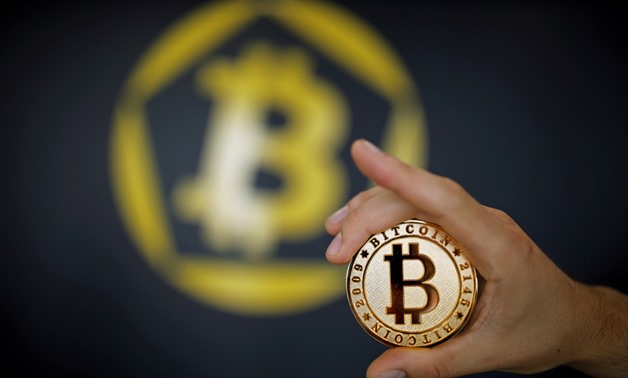 A Bitcoin (virtual currency) coin is seen in an illustration picture taken at La Maison du Bitcoin in Paris, France, June 23, 2017. REUTERS/Benoit Tessier/Illustration
