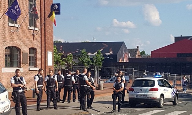 Armed police officers were seen surrounding the area near the police station in Charleroi after the attack - AFP