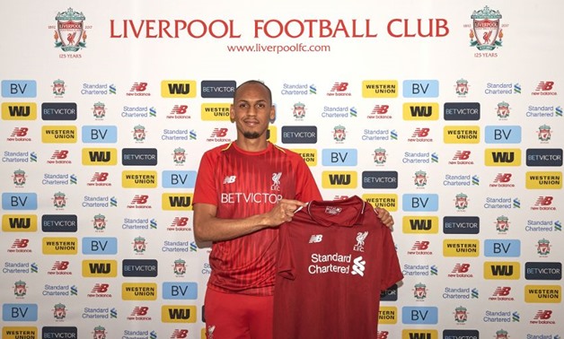 Fabinho holding Liverpool Jersey after signing his contract - Photo courtesy of Liverpool Official website 