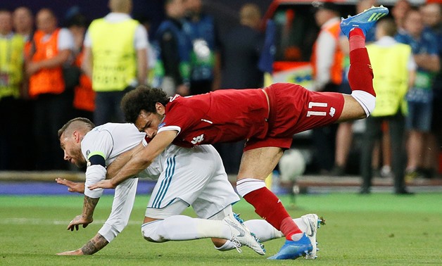 Soccer Football - Champions League Final - Real Madrid v Liverpool - NSC Olympic Stadium, Kiev, Ukraine - May 26, 2018 Liverpool's Mohamed Salah injures his shoulder in a challenge with Real Madrid's Sergio Ramos REUTERS/Gleb Garanich
