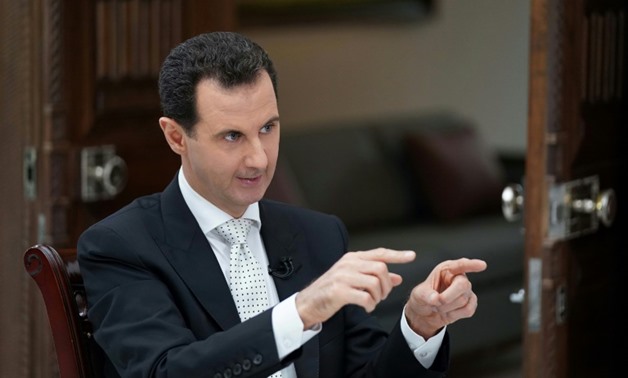 A picture released by the official Syrian Arab News Agency on May 10, 2018 shows Syrian President al-Assad giving an interview to Greek Kathimerini newspaper in Damascus
