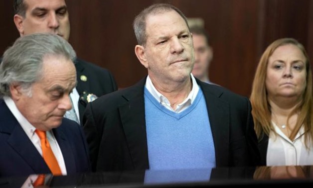 FILE PHOTO: Film producer Harvey Weinstein stands with his lawyer Benjamin Brafman (L) inside Manhattan Criminal Court during his arraignment in Manhattan in New York, U.S., May 25, 2018. Steven Hirsch/Pool via REUTERS.