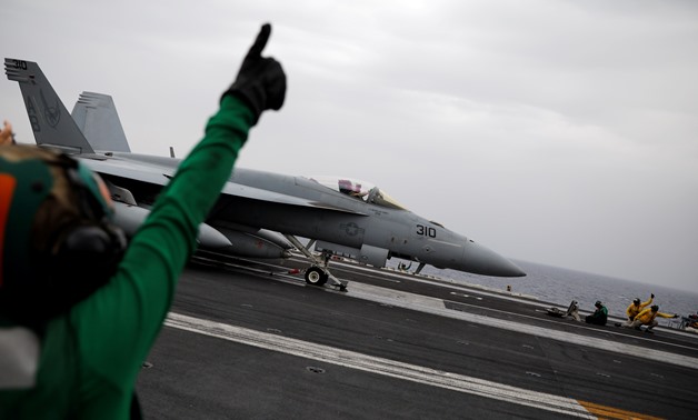 U.S. Navy flight deck personnel use hand signals as an F/A-18 fighter jet prepares to take off from the USS Harry S. Truman aircraft carrier in the eastern Mediterranean Sea, May 4, 2018. Picture taken May 4, 2018. REUTERS/Alkis Konstantinidis