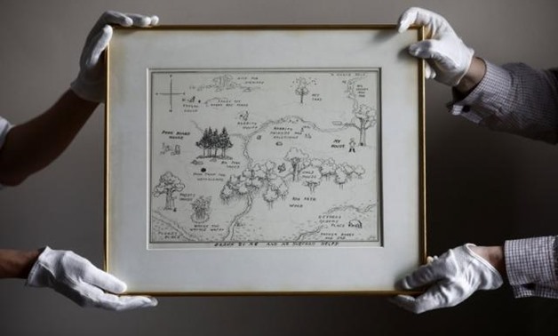 Sotheby's staff hold the original map of Winnie the Pooh's Hundred Acre Wood by E.H Shepard at Sotheby auction rooms in London Britain May 31, 2018. REUTERS/Simon Dawson