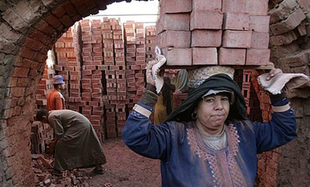 Women. A worker carries bricks in the Egyptian town of Mansoura. (Source: Reuters)
