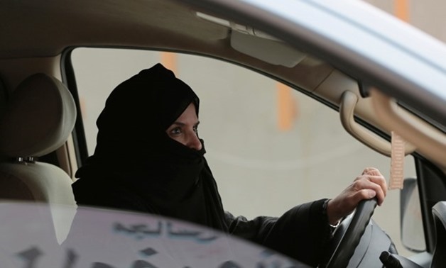 In this March 29, 2014 file photo, Aziza al-Yousef drives a car on a highway in Riyadh, Saudi Arabia, as part of a campaign to defy Saudi Arabia's ban on women driving. (AP Photo/Hasan Jamali, File)