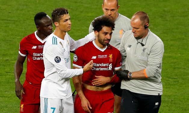 FILE PHOTO: Soccer Football - Champions League Final - Real Madrid v Liverpool - NSC Olympic Stadium, Kiev, Ukraine - May 26, 2018 Liverpool's Mohamed Salah with Sadio Mane and Real Madrid's Cristiano Ronaldo as he is substituted after sustaining an injur