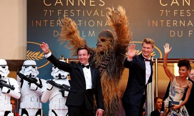 FILE PHOTO: 71st Cannes Film Festival - Screening of the film "Solo: A Star Wars Story" out of competition - Red Carpet Arrivals - Cannes, France May 15, 2018. Producer Simon Emanuel and cast members Joonas Suotamo, Thandie Newton and Chewbacca pose. REUT