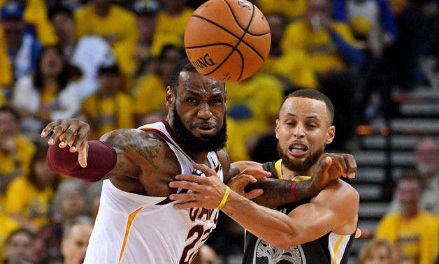June 3, 2018; Oakland, CA, USA; Golden State Warriors guard Stephen Curry (30) and Cleveland Cavaliers forward LeBron James (23) go for a loose ball during the second quarter in game one of the 2018 NBA Finals at Oracle Arena. Mandatory Credit: Kyle Terad