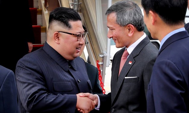 Singapore's Foreign Minister Vivian Balakrishnan welcomes North Korean leader Kim Jong Un on his arrival in Singapore, June 10, 2018 in this picture obtained from social media. MINISTRY OF COMMUNICATIONS AND INFORMATION/via REUTERS THIS IMAGE HAS BEEN SUP