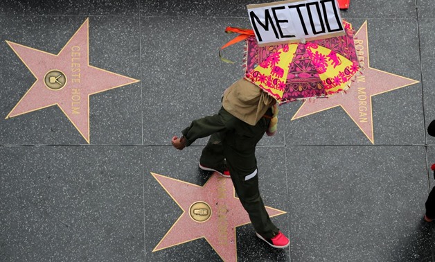 FILE PHOTO: A demonstrator takes part in a #MeToo protest march for survivors of sexual assault and their supporters in Hollywood, Los Angeles, California U.S. November 12, 2017. REUTERS/Lucy Nicholson/File Photo
