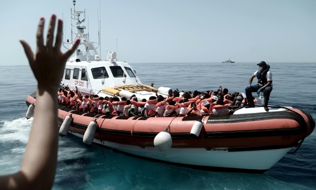 This handout picture from Medecins Sans Frontiers shows rescued migrants onboard an Italian coastguard ship following their transfer from the French NGO's ship Aquarius
