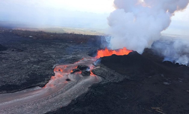 FILE PHOTO - Lava fragments falling from lava fountains at fissure 8 are building a cinder-and-spatter cone around the erupting vent, with the bulk of the fragments falling on the downwind side of the cone as it continues to feed a channelized lava flow t
