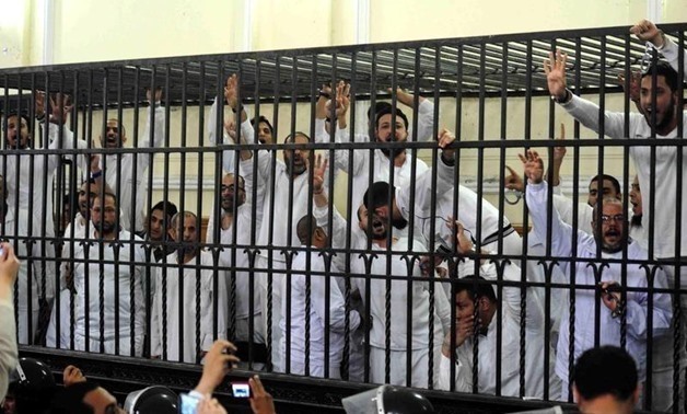 Supporters of former Egyptian president Mohamed Mursi, standing trial on charges of violence that broke out in Alexandria last year in a court in Alexandria, March 29, 2014. REUTERS