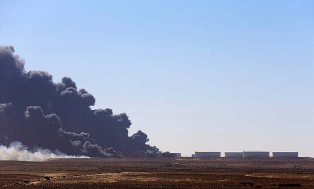 FILE - Black smoke billows out of a storage oil tank at the port of Es Sider in Ras Lanuf- Reuters