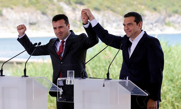 Greek Prime Minister Alexis Tsipras and Macedonian Prime Minister Zoran Zaev gesture before the signing of an accord to settle a long dispute over the former Yugoslav republic's name in the village of Psarades, in Prespes, Greece, June 17, 2018. REUTERS/A