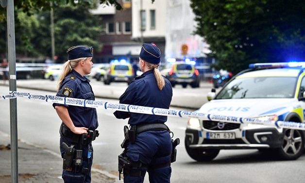 Police stand next to a cordon after a shooting on a street in central Malmo, Sweden June 18, 2018. TT News Agency/Johan Nilsson/via REUTERS ATTENTION EDITORS - THIS IMAGE WAS PROVIDED BY A THIRD PARTY. SWEDEN OUT. NO COMMERCIAL OR EDITORIAL SALES IN SWEDE
