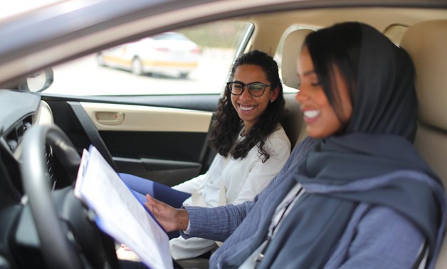 Driving instructor Ahlam al-Somali (R) reads instructions before getting ready to drive with trainee Maria al-Faraj at Saudi Aramco Driving Center in Dhahran, Saudi Arabia, June 6, 2018. REUTERS/Ahmed Jadallah
